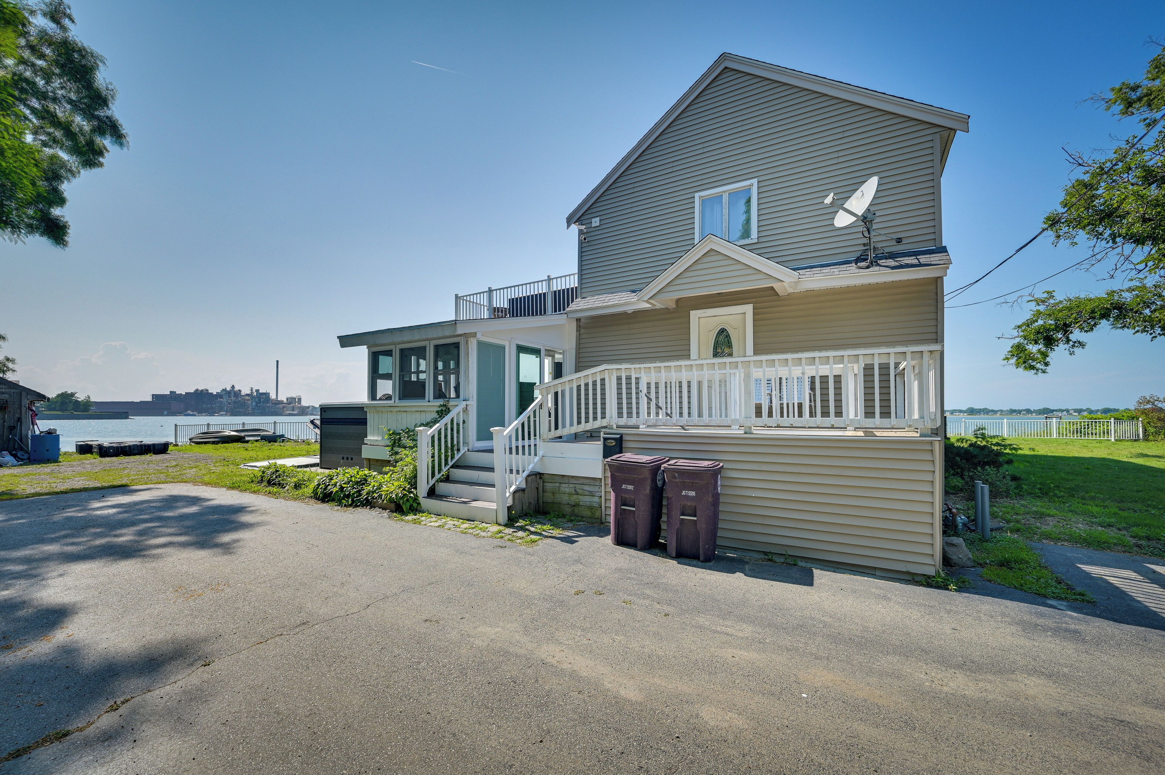 A two-story house with a balcony, a satellite dish, and a small porch.