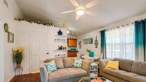 A living room with a ceiling fan, a dining area, and a kitchen in the background. - Lakefront Keystone Heights Home w/ Boat Ramp! (Keystone Heights)