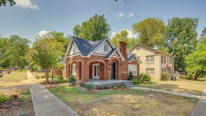 A two-story house with a brick facade, a front porch, and a well-maintained lawn. - Walk to Bergfeld Park: 1928 Azalea District Home (Tyler)