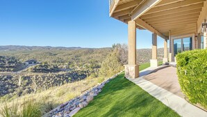 A modern building with a covered patio overlooking a mountainous landscape. - Prescott Gem: Hot Tub & Mtn Views, 7 Mi to Dtwn (Prescott)