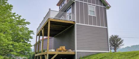 A two-story house with a balcony and a wooden deck.