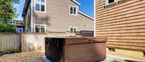 A house with a hot tub in the backyard.