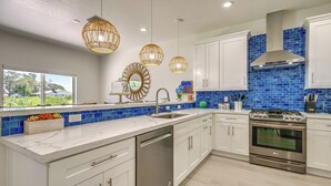 A modern kitchen with white cabinets, a stainless steel dishwasher, and an LG oven. - Sebring Serenity: Waterfront Retreat w/ Boat Dock! (Sebring)