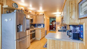 Une cuisine moderne avec des meubles en bois, des appareils en acier inoxydable et un îlot central.