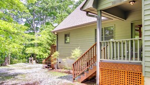 A house with a porch, wooden stairs, and a small garden area. - Relaxing Saluda Home Near Waterfall Trails! (Saluda)
