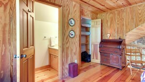 A wooden interior with a wooden cabinet, a suitcase, and a bed. - Relaxing Saluda Home Near Waterfall Trails! (Saluda)