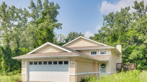 A single-story house with a garage, a front porch, and a small deck. - 1 Mi to Indiana Dunes NP: Spacious Gary Home! (Gary)