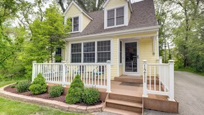 A two-story house with a front porch, a small deck, and a mailbox. - Steps to Lake Michigan Beach: Gary Vacation Rental (Gary)