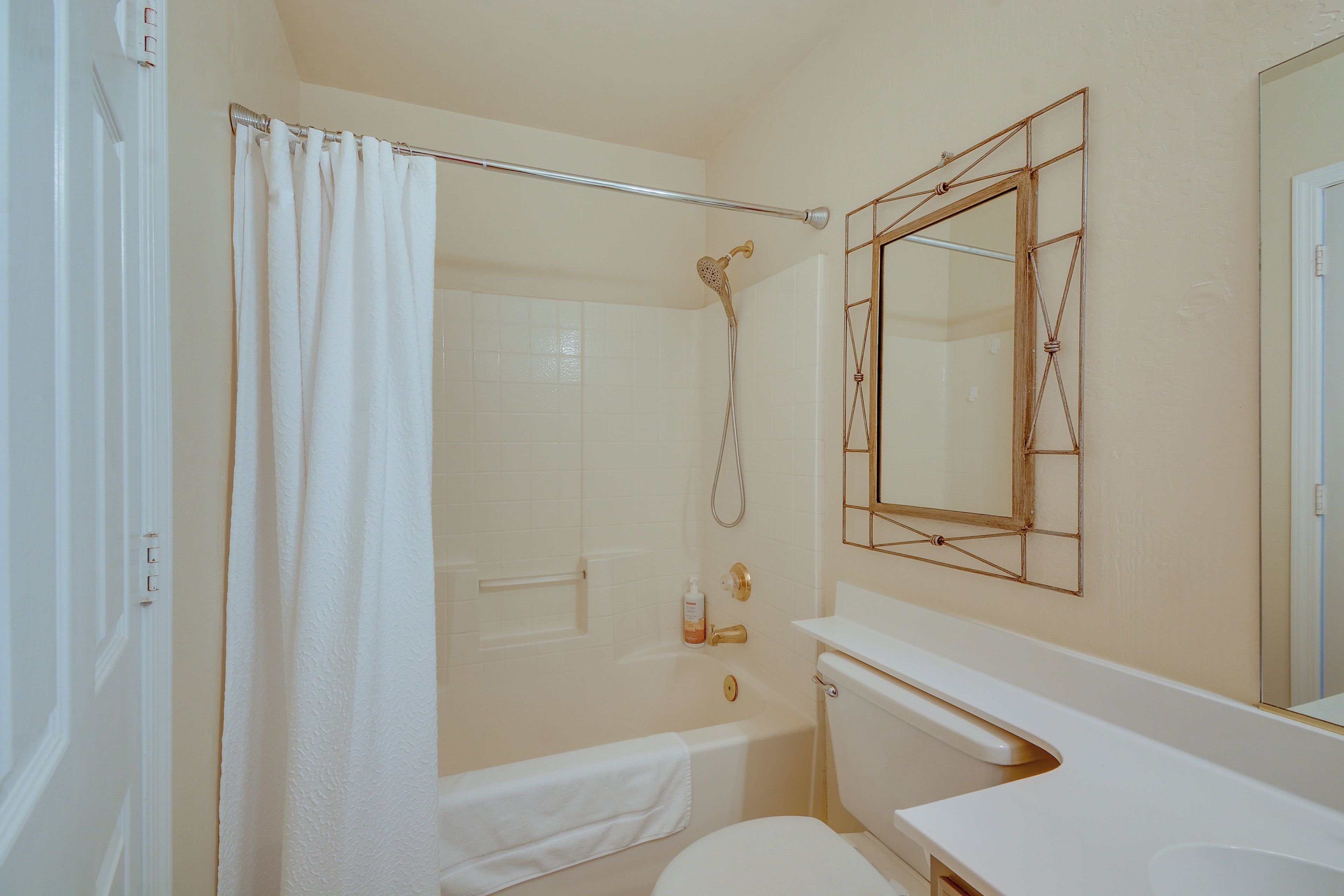 A bathroom with a bathtub, toilet, and a shower.
