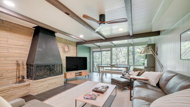 A modern living room with a fireplace, leather sofa, and a television. - Idyllic Eufaula Vacation Rental: Close to Lake! (Eufaula)