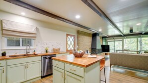 A modern kitchen with wooden countertops, a dishwasher, and a large window. - Idyllic Eufaula Vacation Rental: Close to Lake! (Eufaula)