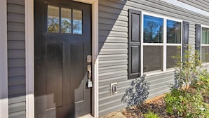 A house with a dark front door, a small window, and a mailbox. - Greer Getaway w/ Smart TV ~ 1 Mi to Dtwn! (Greer)