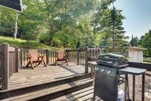 A wooden deck with two Adirondack chairs, a grill, and a small shed. - Eagle River Retreat Near Dam Lake w/ Boat Dock! (Eagle River)
