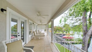 A covered balcony with chairs, a view of a lake, and a tree. - Lakefront Hot Springs Condo w/ Dock Access & Views (Hot Springs)