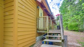 A wooden building with a porch and steps leading to a door. - Waterfront 'UP Badger Lodge Bnb' on Powell Lake (Wetmore)