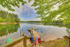 A calm lake with a wooden dock, surrounded by trees. - Waterfront 'UP Badger Lodge Bnb' on Powell Lake (Wetmore)