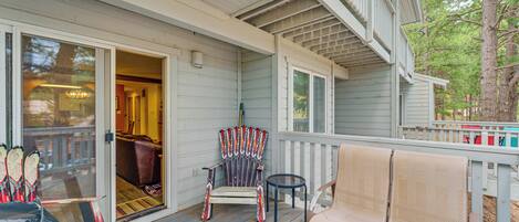 A porch with a chair, a bench, and a table.