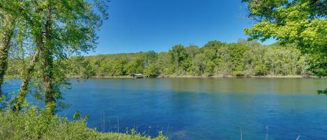A serene lake surrounded by lush greenery and trees.