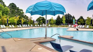 A swimming pool with blue umbrellas, lounge chairs, and a tiled deck. - 3 Mi to Bethany Beach: Ocean View Home w/ Patio (Ocean View)