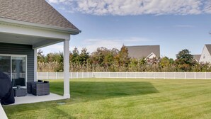 A covered patio area with outdoor furniture, a white fence, and a well-maintained lawn. - 3 Mi to Bethany Beach: Ocean View Home w/ Patio (Ocean View)