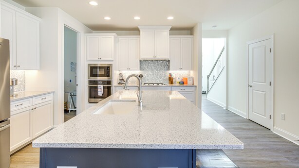 A modern kitchen with white cabinetry, a granite countertop, and stainless steel appliances. - Ocean View Home w/ Kayaks ~ 2 Mi to Bethany Beach (Ocean View)