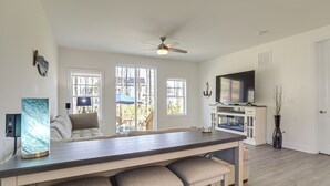A modern kitchen with a central island, large windows, and a ceiling fan. - Ocean View Home w/ Kayaks ~ 2 Mi to Bethany Beach (Ocean View)