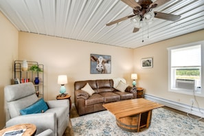 Relax in this inviting living room with a leather sofa, coffee table, and armchair.