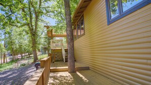A wooden cabin with a deck, surrounded by trees. - Strawberry Cabin Rental w/ Deck & Mountain Views! (Pine)