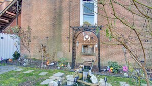 A brick building with a small garden, a wooden pergola, and a pond. - < 2 Mi to Downtown & Capitol: Harrisburg Hideaway (Harrisburg)