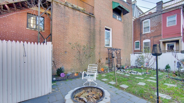 A backyard with a fire pit, a white chair, and a white picket fence. - < 2 Mi to Downtown & Capitol: Harrisburg Hideaway (Harrisburg)