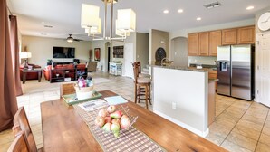 A spacious kitchen with a central island, wooden cabinets, and stainless steel appliances. - Maricopa Oasis w/ Game Room + Community Perks! (Maricopa)