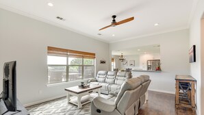 A spacious living room with a large sectional sofa, a coffee table, and a television. - Inviting Granbury Home w/ Fire Pit: 3 Mi to Lake! (Granbury)