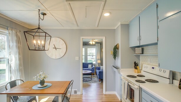 A modern kitchen with a dining area, wooden flooring, and a view into the living room. - Sturgeon Bay Home ~ 6 Mi to Potawatomi State Park (Sturgeon Bay)