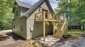 A two-story house with a wooden deck and a staircase leading to a balcony. - Dog-friendly Mills River Retreat Near Hiking! (Mills River)