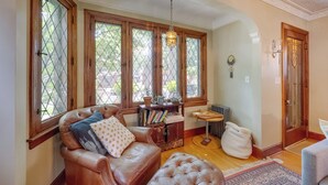 Un salon chaleureux avec un canapé en cuir, une table basse en bois et une bibliothèque.