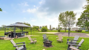 A gazebo with a grill, outdoor seating, and a fire pit. - Welcoming Port Clinton Vacation Rental! (Port Clinton)