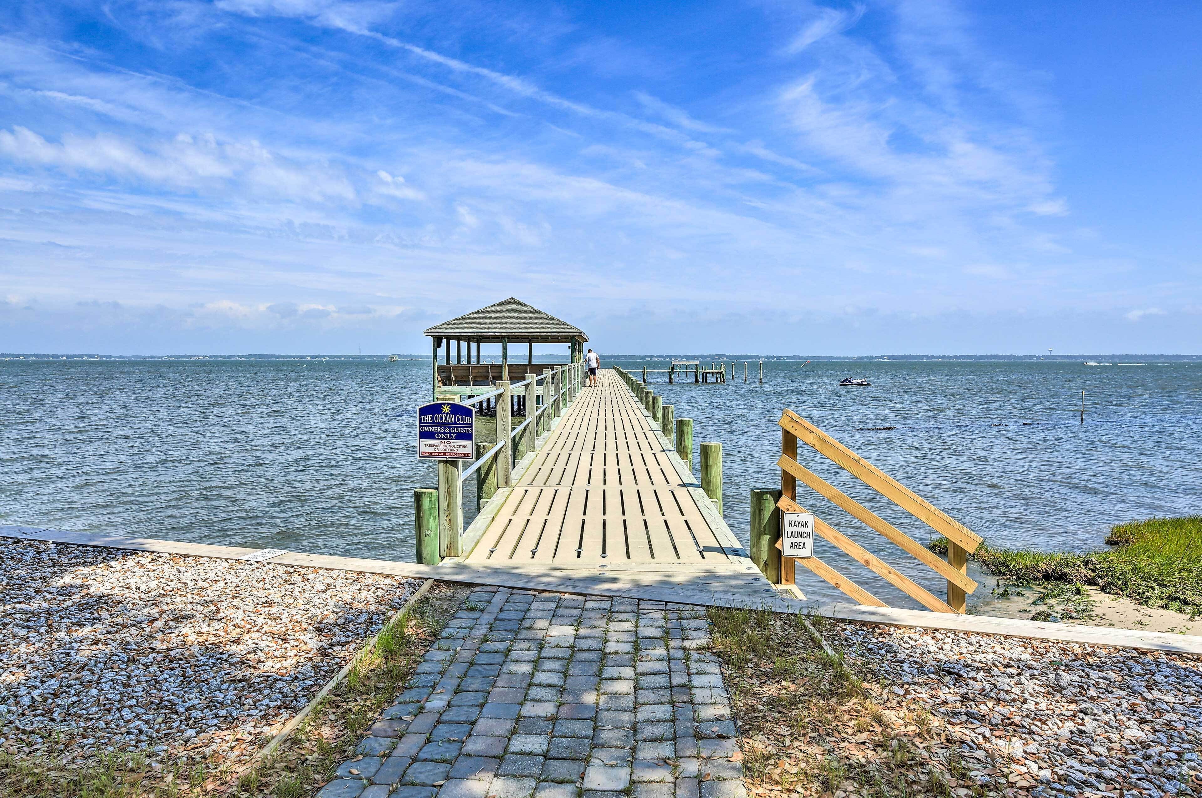 A wooden pier leading to a gazebo with a sign reading "The Ocean Club Owners & Guests".