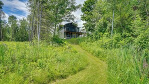 A modern house surrounded by dense forest. - Riverfront Escape in Shawano on 3 Private Acres! (Shawano)