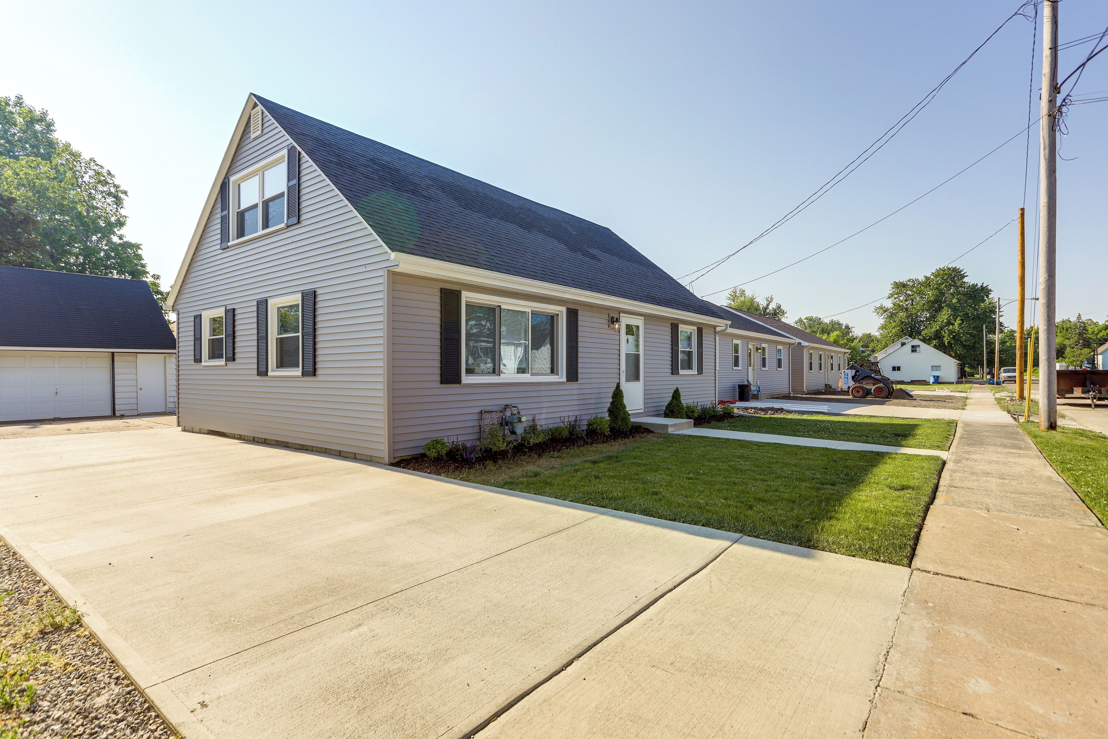 A single-story house with a sloped roof, a front porch, and a well-maintained lawn.