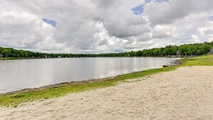 A wide sandy beach with a calm lake and a forested shoreline. - 5 Mi to Tobyhanna State Park: Home w/ Game Room! (Tobyhanna)