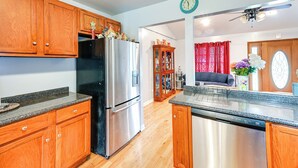 A kitchen with wooden cabinets, stainless steel appliances, and a dishwasher. - Peaceful Getaway in Blonts Creek Near Washington (Blounts Creek)