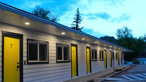 A motel with six rooms, each with a distinct number and a yellow door. - Queen City Inn (Spearfish)