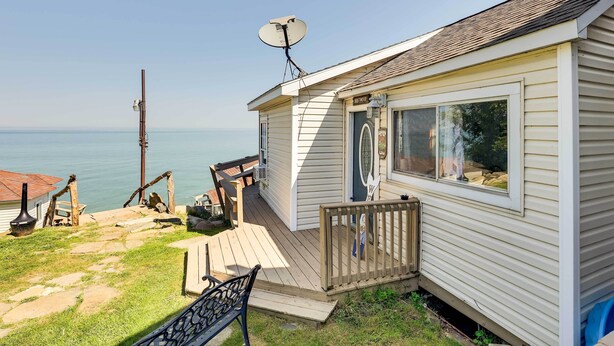 A mobile home with a satellite dish, a deck, and a view of the water. - Lakefront Geneva Vacation Rental - Walk to Strip! (Geneva)