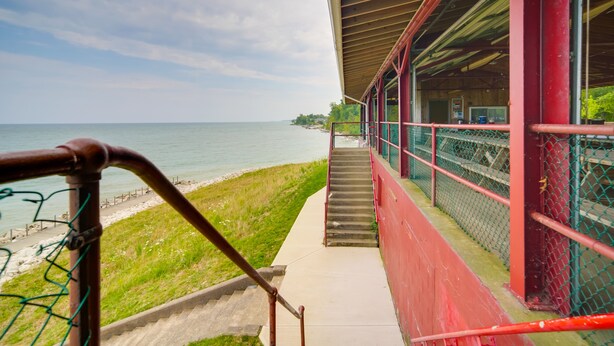 A staircase leading to a building with a view of the sea. - Charming Lake Erie Cottage on Main Strip! (Geneva)