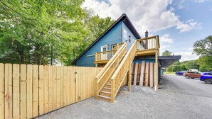 A two-story building with a wooden deck and a staircase leading to the upper floor. - Old Forge Studio: Close to Lakes & Hiking Trails (Old Forge)