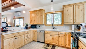 A modern kitchen with wooden cabinets, a dishwasher, a microwave, and a stove. - Mountain Retreat in Drake w/ Fireplace & Views! (Drake)