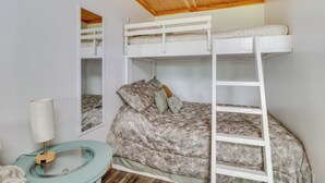 A bunk bed room with a wooden ceiling, a bedside table with a lamp, and a mirror on the wall. - Norfork Studio by White River: Ideal for Fishing! (Norfork)