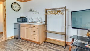 A compact kitchen with a microwave, coffee maker, and a clock on the wall. - Norfork Studio by White River: Ideal for Fishing! (Norfork)