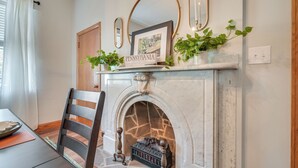 A fireplace with a sign reading "Pennsylvania," a framed picture above it, and a potted plant on the mantel. - Cozy Pennsylvania Retreat Near Hiking & Golfing! (Bedford)