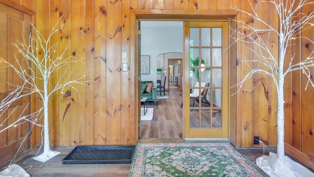 A wooden interior with a door leading to a living area. - Cozy Pennsylvania Retreat Near Hiking & Golfing! (Bedford)